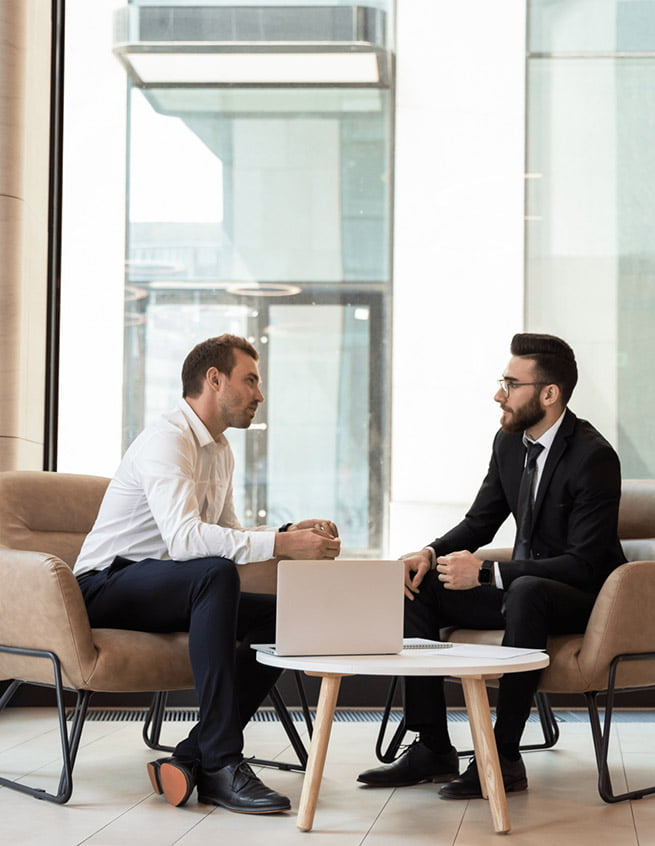 Real estate agent and client discussing in upscale office setting