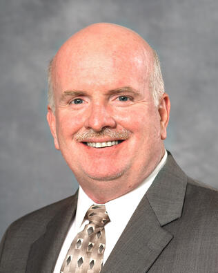 Headshot of James Sweeney
