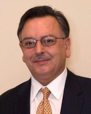 Headshot of John E Gonsalves