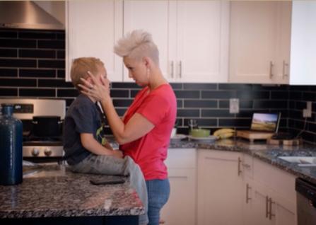 Woman comforting child in a kitchen